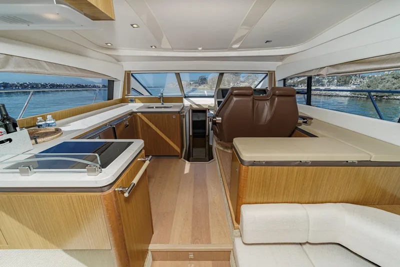 Slide: The Image of Luxurious interior of 2018 Sea Ray Fly 510 yacht with modern kitchen and seating. - 21
