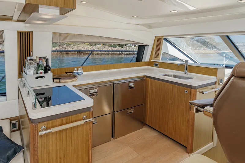 Slide: The Image of Luxurious 2018 Sea Ray Fly 510 yacht kitchen with modern appliances and scenic water view. - 22