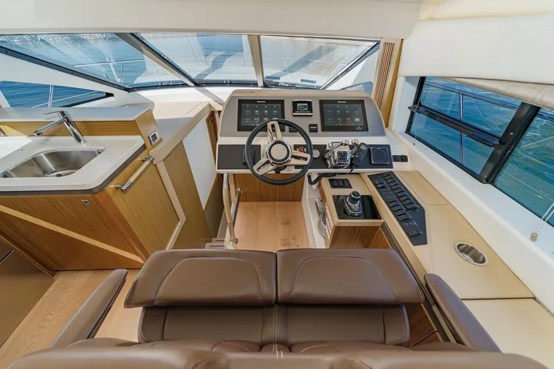 Slide: The Image of Luxurious 2018 Sea Ray Fly 510 yacht helm with modern controls and sleek interior design. - 28