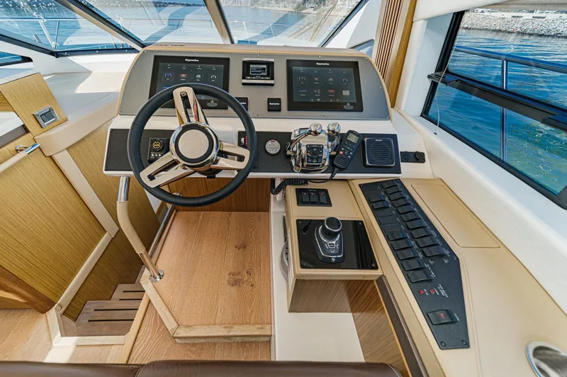 Slide: The Image of 2018 Sea Ray Fly 510 helm with modern controls and navigation systems. - 29