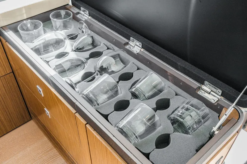 Slide: The Image of Glassware storage in 2018 Sea Ray Fly 510 yacht, featuring secure foam inserts. - 32