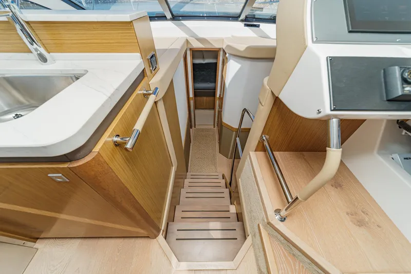 Slide: The Image of Interior view of 2018 Sea Ray Fly 510 yacht, featuring stairs and modern kitchen area. - 33