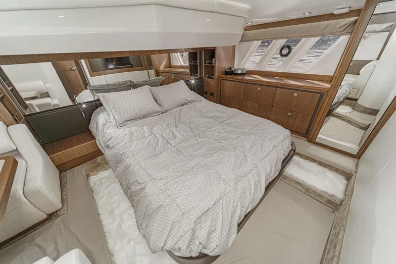 Slide: The Image of Luxurious bedroom interior of 2018 Sea Ray Fly 510 yacht with elegant wood finishes. - 34