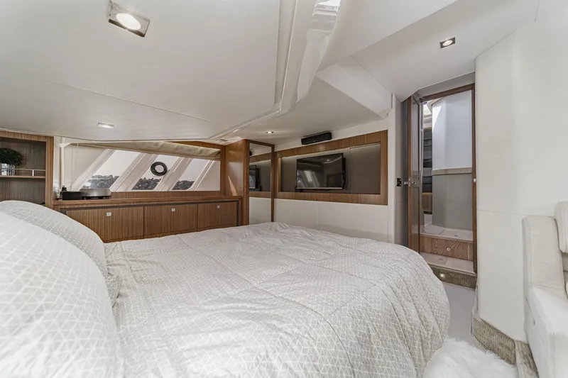 Slide: The Image of Luxurious 2018 Sea Ray Fly 510 yacht bedroom with modern decor and natural light. - 37
