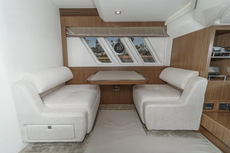 Slide: The Image of Luxurious interior of 2018 Sea Ray Fly 510 yacht with elegant seating and table. - 39