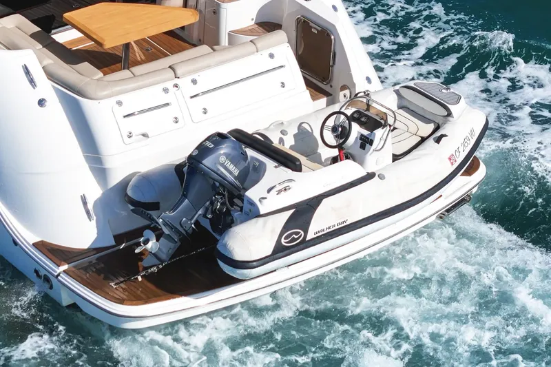 Slide: The Image of 2018 Sea Ray Fly 510 yacht with a Walker Bay tender on the water. - 5