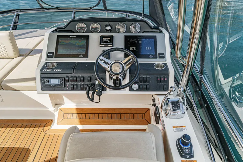 Slide: The Image of 2018 Sea Ray Fly 510 helm with advanced navigation and control systems. - 50