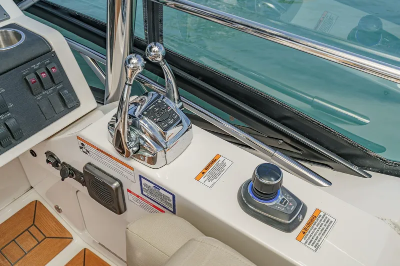 Slide: The Image of Control panel of 2018 Sea Ray Fly 510 yacht with throttle and joystick controls. - 51