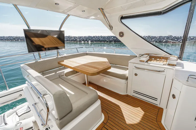 Slide: The Image of Luxurious 2018 Sea Ray Fly 510 yacht interior with seating, table, and ocean view. - 55