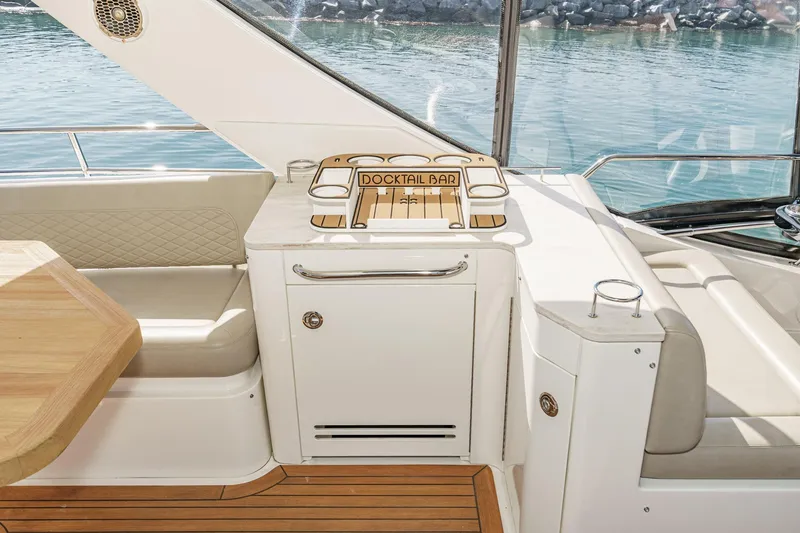 Slide: The Image of Luxurious 2018 Sea Ray Fly 510 yacht interior with cocktail bar and seating area. - 56