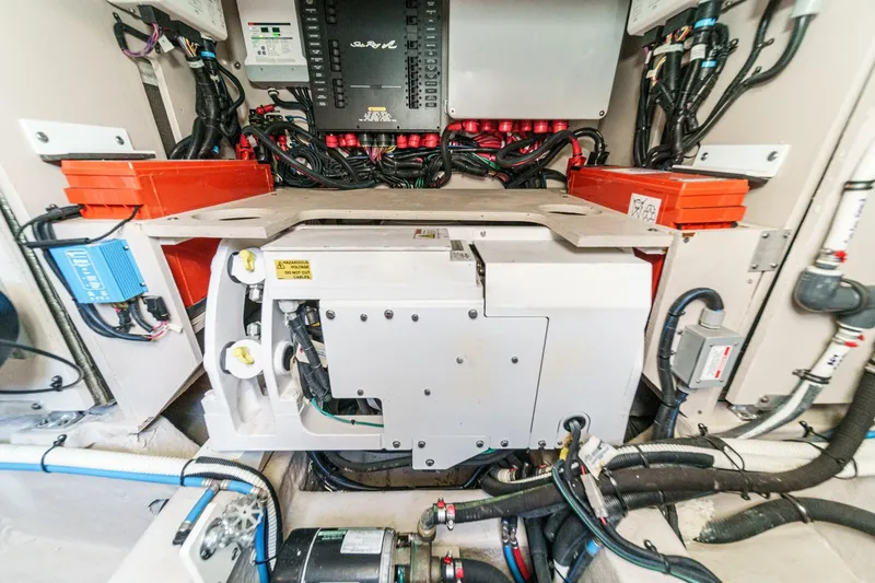 Slide: The Image of Engine room of 2018 Sea Ray Fly 510 yacht with complex wiring and equipment. - 66