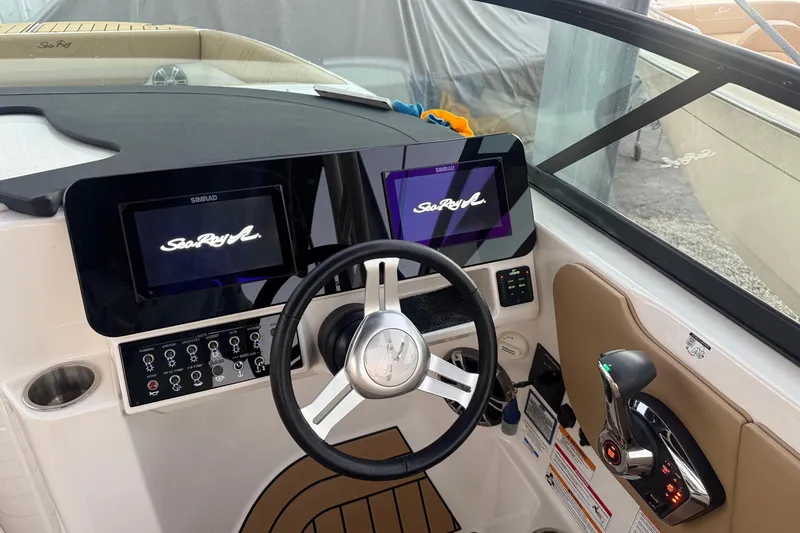 Slide: The Image of 2025 Sea Ray SDX 270 Outboard dashboard with dual Simrad displays and modern controls. - 15