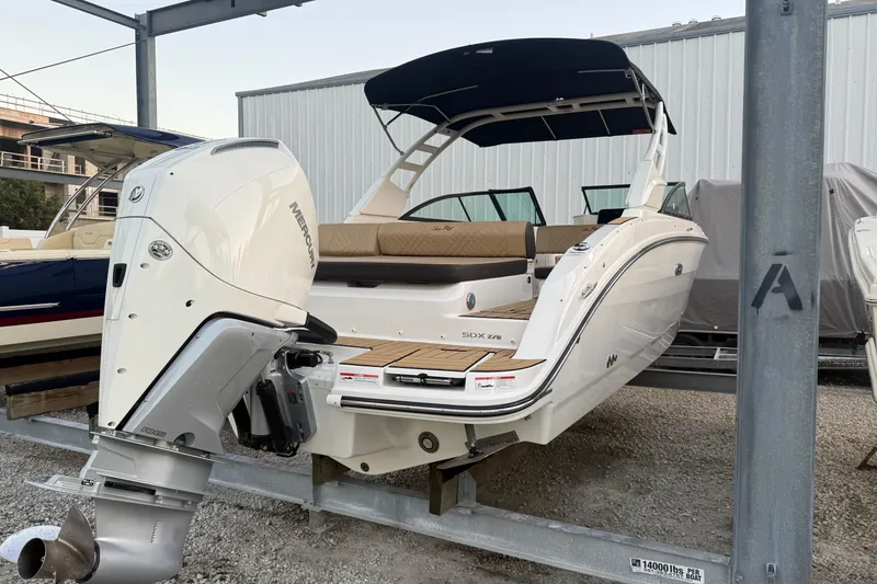 Slide: The Image of 2025 Sea Ray SDX 270 Outboard boat with Mercury engine, docked in a marina. - 2