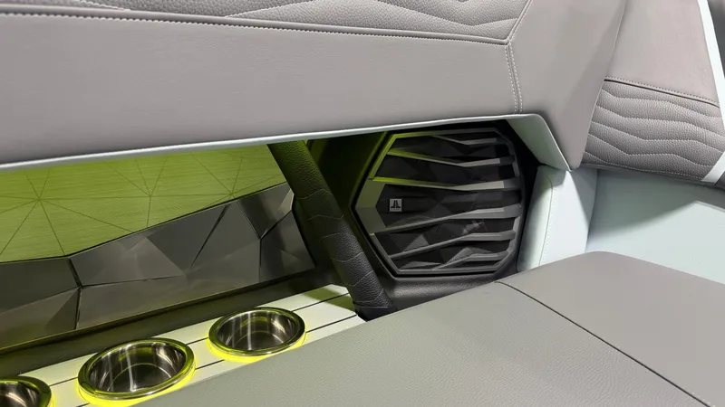 Slide: The Image of Close-up of a speaker and cup holders in the interior of a Nautique Super Air Nautique G25. - 30