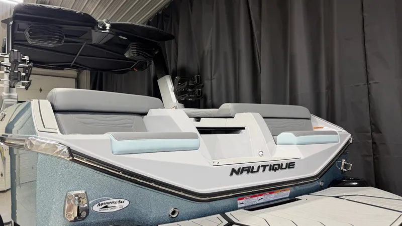 Slide: The Image of The image shows the stern of a 2026 Nautique Super Air Nautique G25 with gray upholstery. - 13