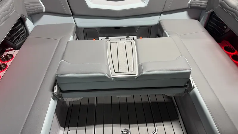 Slide: The Image of The image shows the interior of a 2026 Nautique Super Air Nautique G25 with gray upholstery. - 33