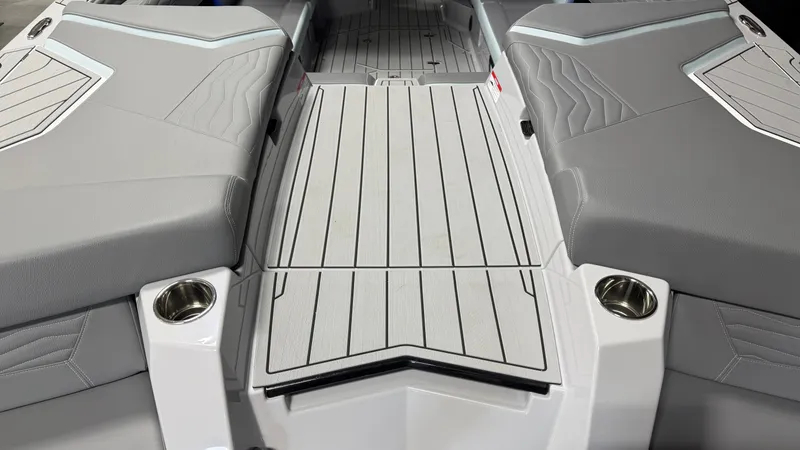 Slide: The Image of The image shows the deck of a 2026 Nautique Super Air Nautique G25 with gray upholstery. - 22