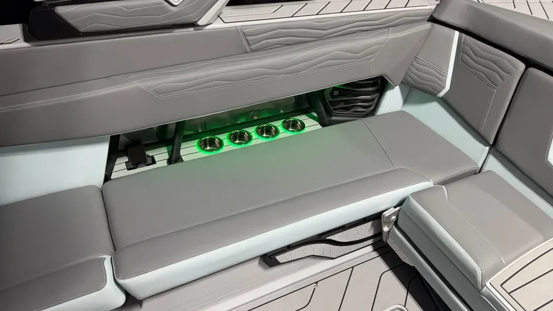 Slide: The Image of The image shows the interior of a modern boat with gray upholstery and illuminated cup holders. - 27