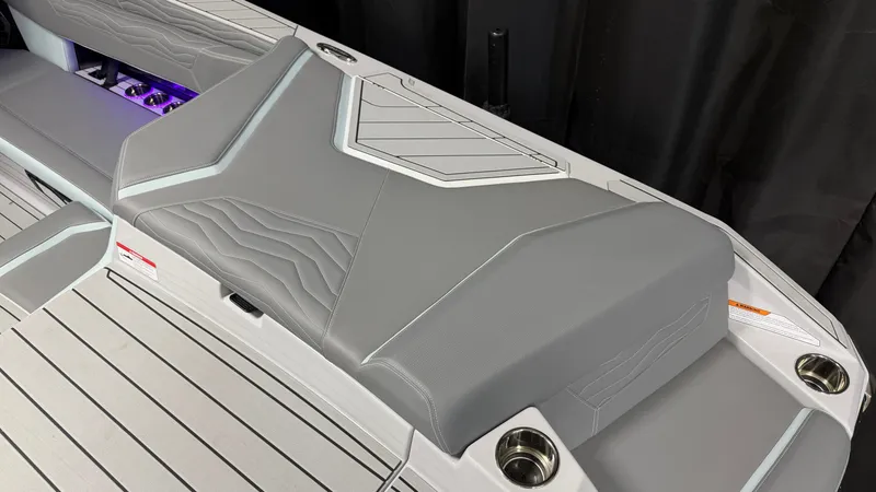Slide: The Image of The image shows the gray upholstery of a 2026 Nautique Super Air Nautique G25. - 20