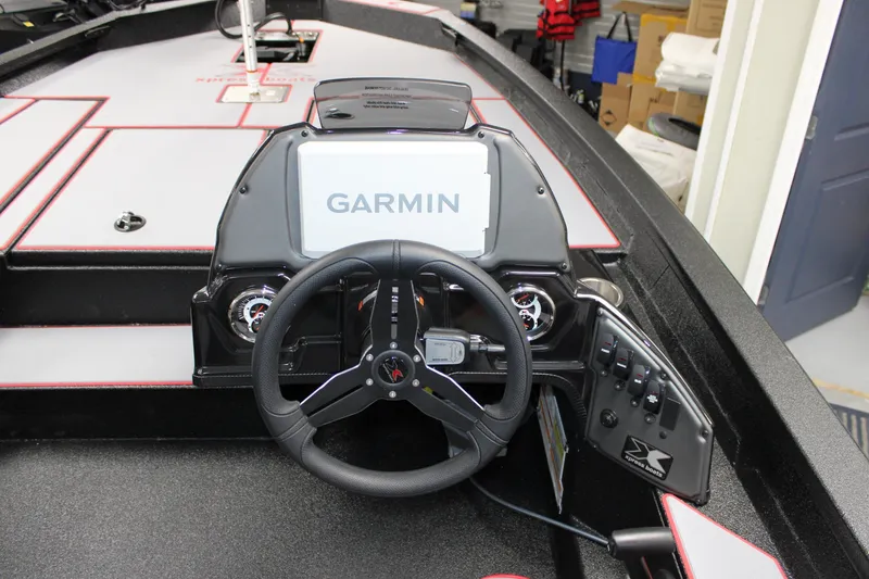 Slide: The Image of 2026 Xpress H18 boat dashboard with Garmin navigation system and steering wheel. - 7