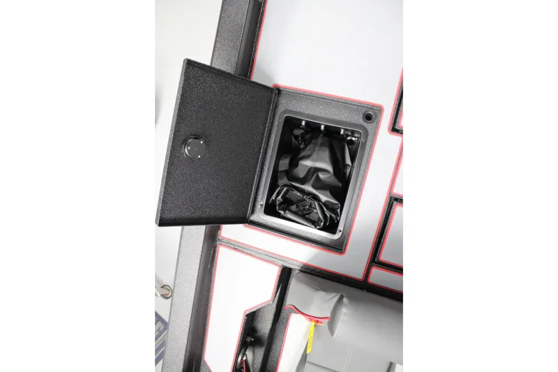 Slide: The Image of Open storage compartment in 2026 Xpress H18 boat with black interior. - 8
