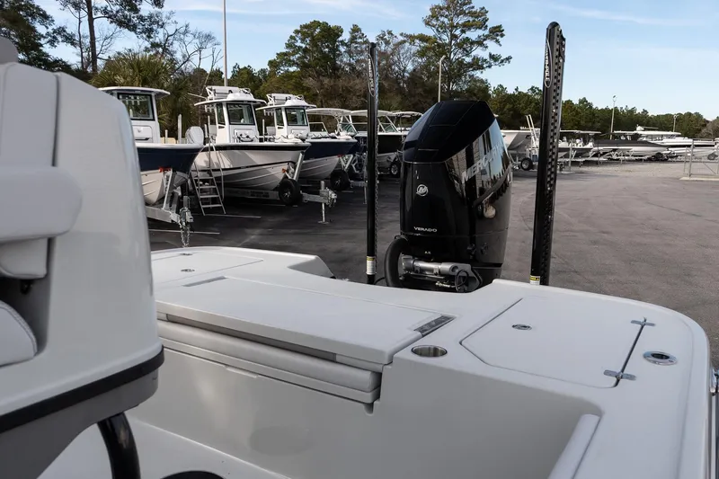 Slide: The Image of 2026 Caymas 28 HB boat with Mercury engine in a marina setting. - 10