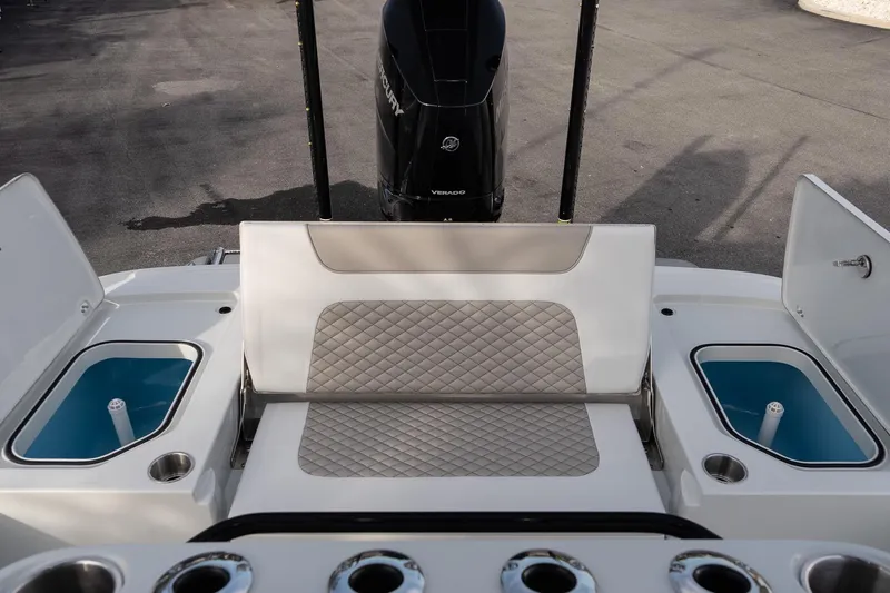 Slide: The Image of 2026 Caymas 28 HB boat interior with seating, storage compartments, and Mercury engine. - 12