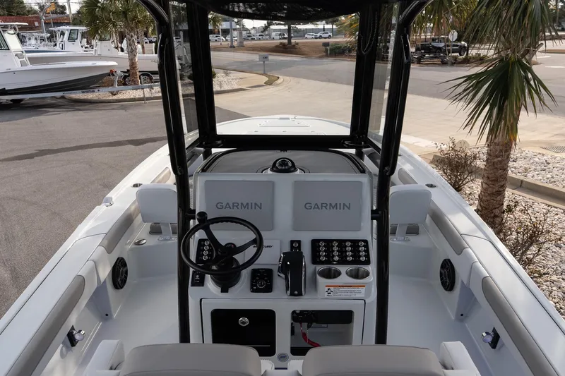 Slide: The Image of 2026 Caymas 28 HB boat cockpit with Garmin navigation system, steering wheel, and control panel. - 13