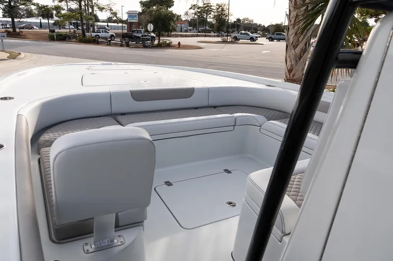 Slide: The Image of 2026 Caymas 28 HB boat interior with cushioned seating and storage compartments. - 22