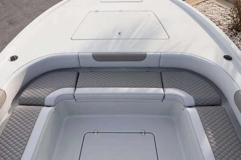 Slide: The Image of 2026 Caymas 28 HB boat interior with cushioned seating and storage compartments. - 23