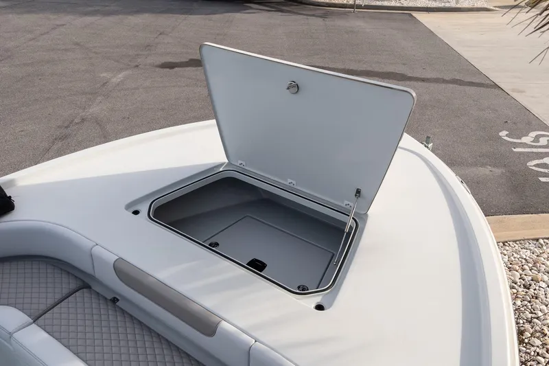 Slide: The Image of 2026 Caymas 28 HB boat with open storage compartment on deck. - 25