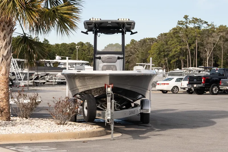 Slide: The Image of 2026 Caymas 28 HB boat on trailer in parking lot, surrounded by trees and vehicles. - 4