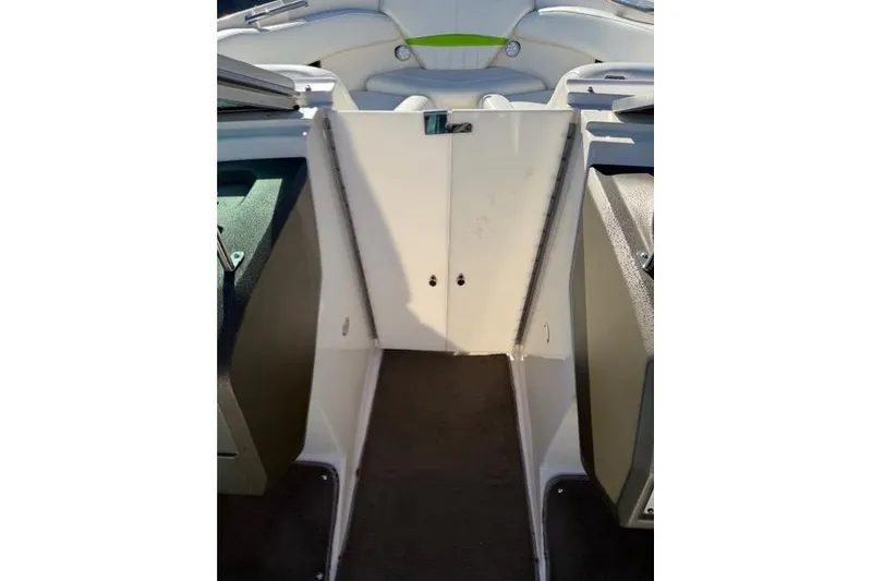 Slide: The Image of 2005 Regal 2200 Bowrider interior, featuring a clean, spacious walkway and seating area. - 13