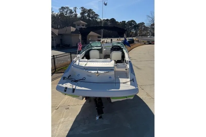 Slide: The Image of 2005 Regal 2200 Bowrider boat parked on a driveway, rear view. - 3