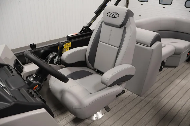 Slide: The Image of 2026 Bentley Pontoons 223 Navigator Tri-toon interior with luxurious captain's chair and steering console. - 29