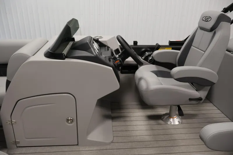 Slide: The Image of 2026 Bentley Pontoons 223 Navigator Tri-toon interior with sleek helm and comfortable captain's chair. - 17