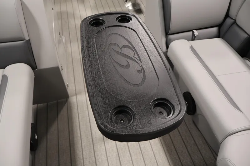 Slide: The Image of Luxury interior of 2026 Bentley Pontoons 223 Navigator Tri-toon with sleek table and cup holders. - 16