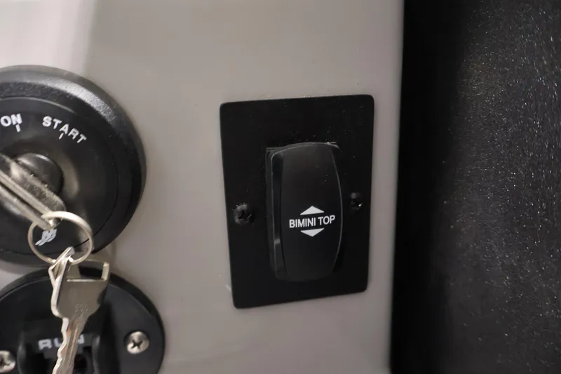 Slide: The Image of Close-up of ignition switch and Bimini top control on 2026 Bentley Pontoons 223 Navigator Tri-toon. - 27