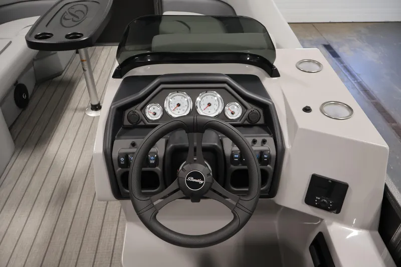Slide: The Image of 2026 Bentley Pontoons 223 Navigator Tri-toon dashboard with steering wheel and gauges. - 19