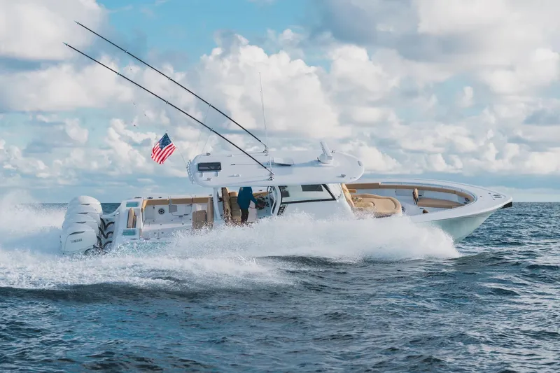 Slide: The Image of 2026 Sportsman Open 402 Center Console boat cruising on ocean with American flag. - 2