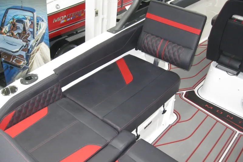 Slide: The Image of 2025 Monterey Elite 27 OB boat interior with stylish black and red seating. - 10
