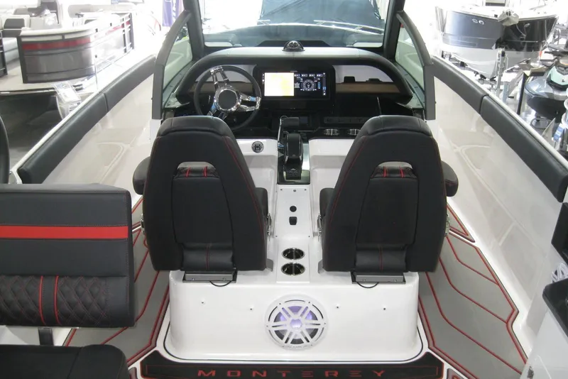 Slide: The Image of 2025 Monterey Elite 27 OB boat interior with stylish black and red seating. - 11