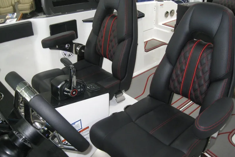 Slide: The Image of 2025 Monterey Elite 27 OB boat dashboard with steering wheel and digital display. - 16