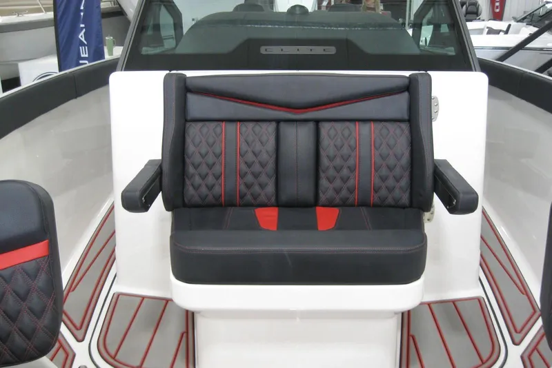 Slide: The Image of 2025 Monterey Elite 27 OB boat interior with seating and compass in a showroom. - 20