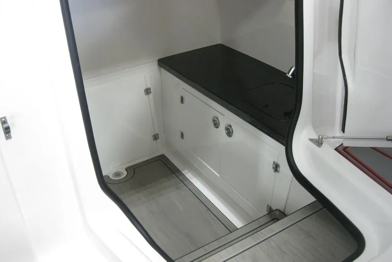 Slide: The Image of Luxury seating on 2025 Monterey Elite 27 OB boat with black and red accents. - 21