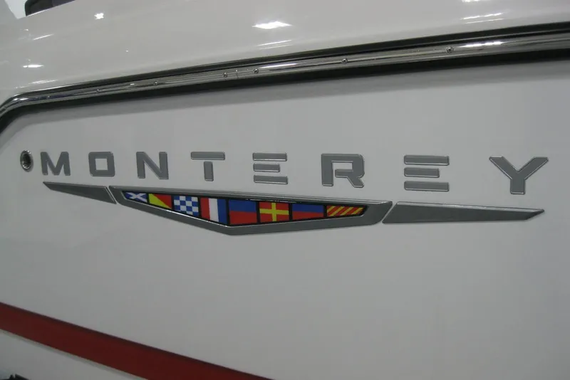 Slide: The Image of 2025 Monterey Elite 27 OB boat displayed in showroom, featuring sleek design and modern seating. - 4
