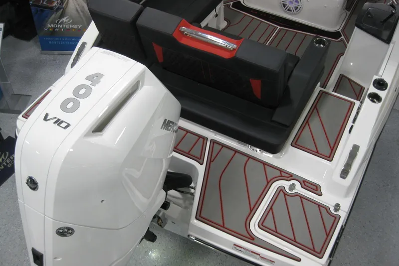 Slide: The Image of 2025 Monterey Elite 27 OB boat displayed in a showroom, rear view. - 6