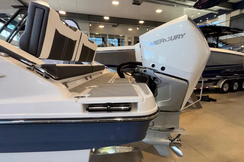 Slide: The Image of 2026 Monterey Elite 30 OB boat with Mercury outboard engine in showroom. - 100