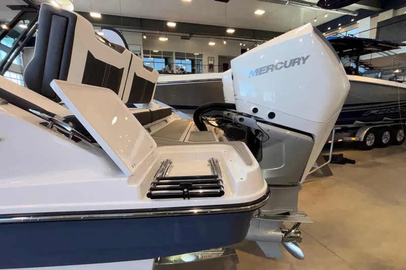Slide: The Image of 2026 Monterey Elite 30 OB boat with Mercury outboard engine in showroom. - 101