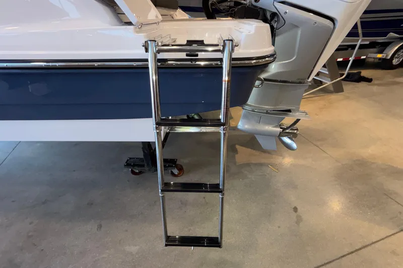 Slide: The Image of Stainless steel ladder on 2026 Monterey Elite 30 OB boat, docked indoors. - 102